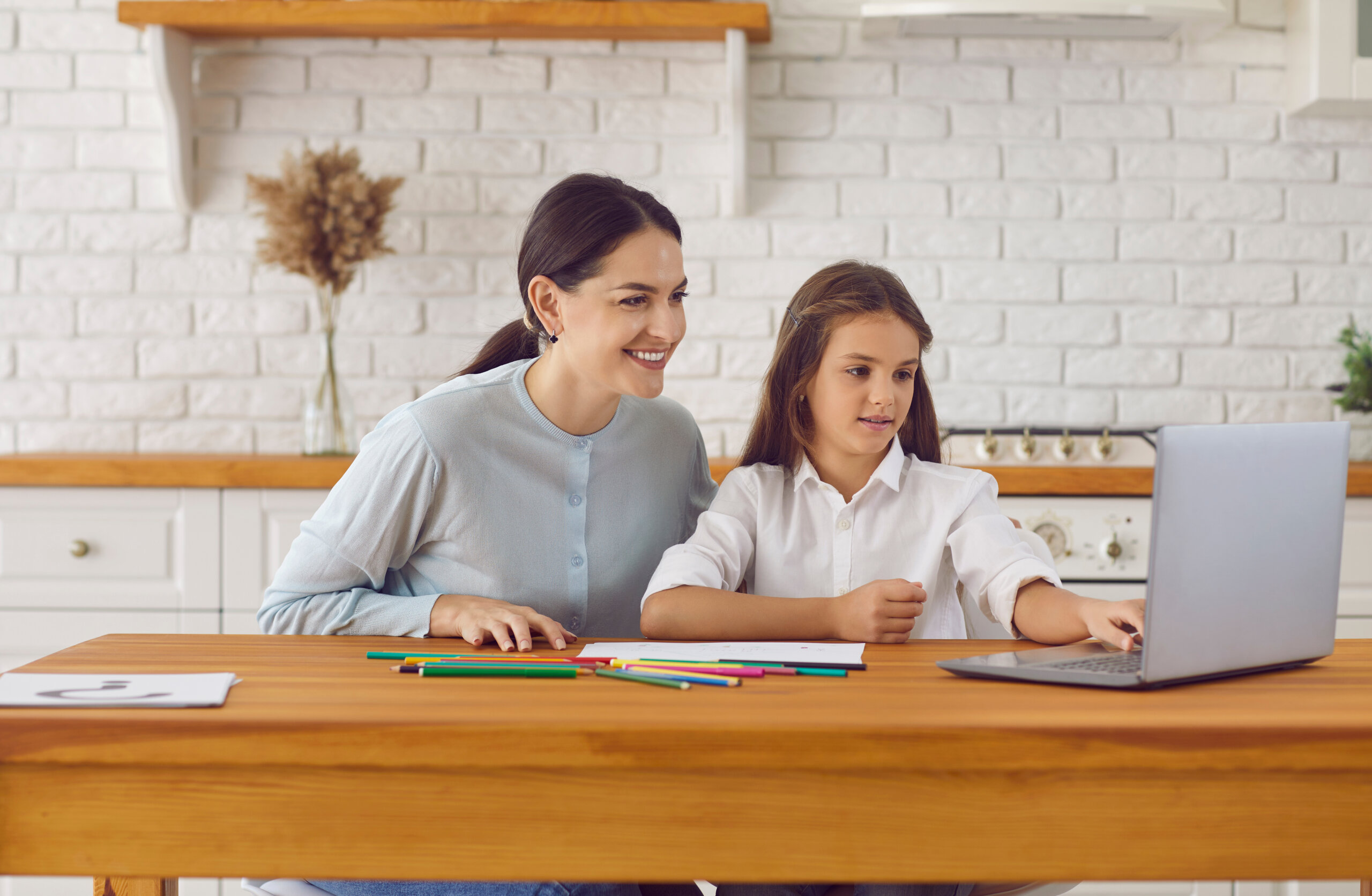 Mother and daughter looking at a laptop together